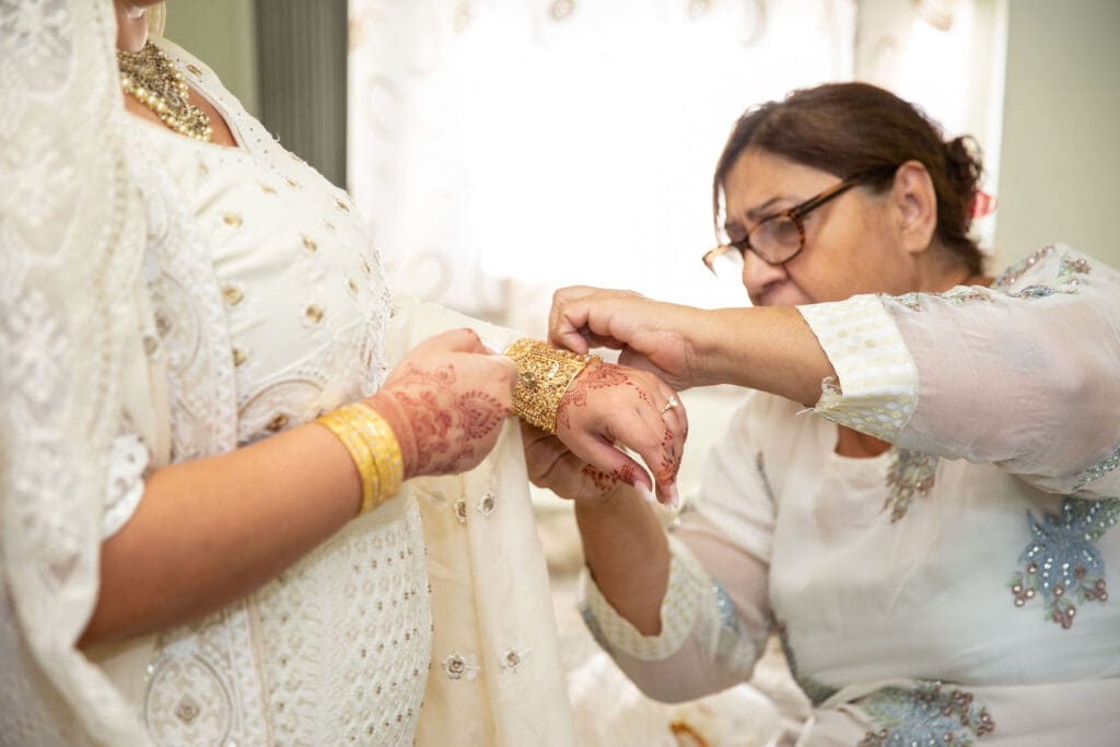 Brooklyn Nikkah Elopement. Mom of Bride helping bride get ready before the ceremony.