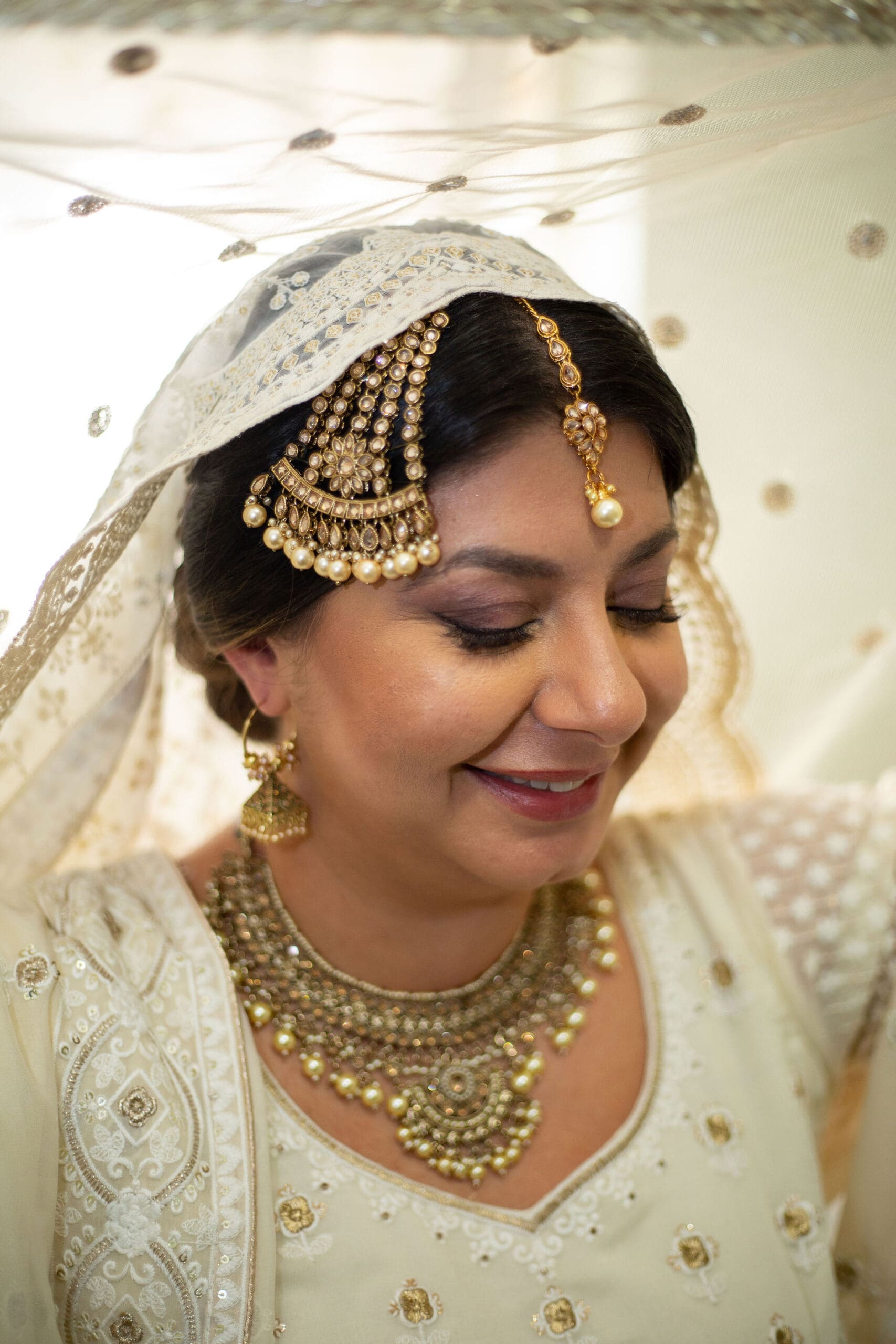 Brooklyn Nikkah Elopement. Portrait of bride with veil on in full jewelry and henna before the ceremony.
