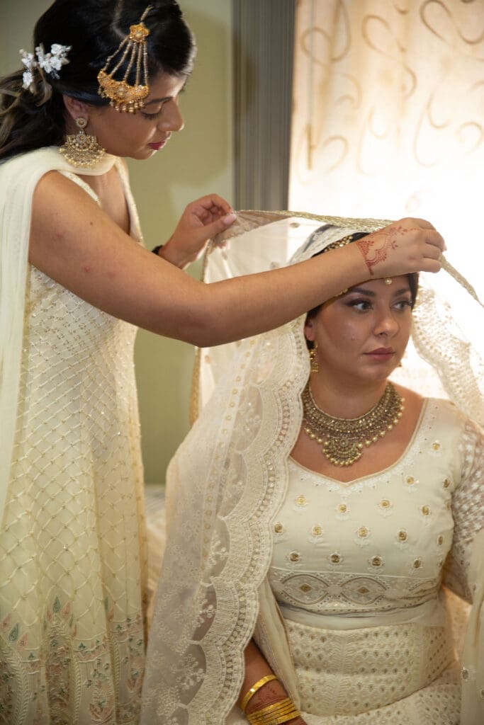 Brooklyn Nikkah Elopement. Portrait of bride's sister helping her get ready before the ceremony.