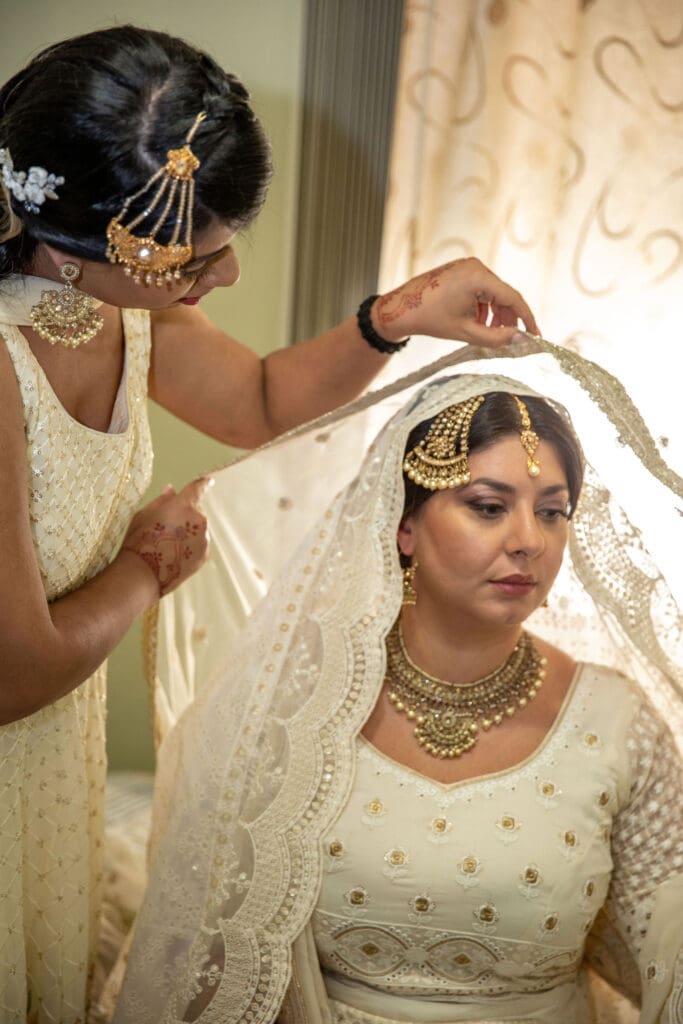 Brooklyn Nikkah Elopement. Portrait of bride's sister helping her get ready before the ceremony.