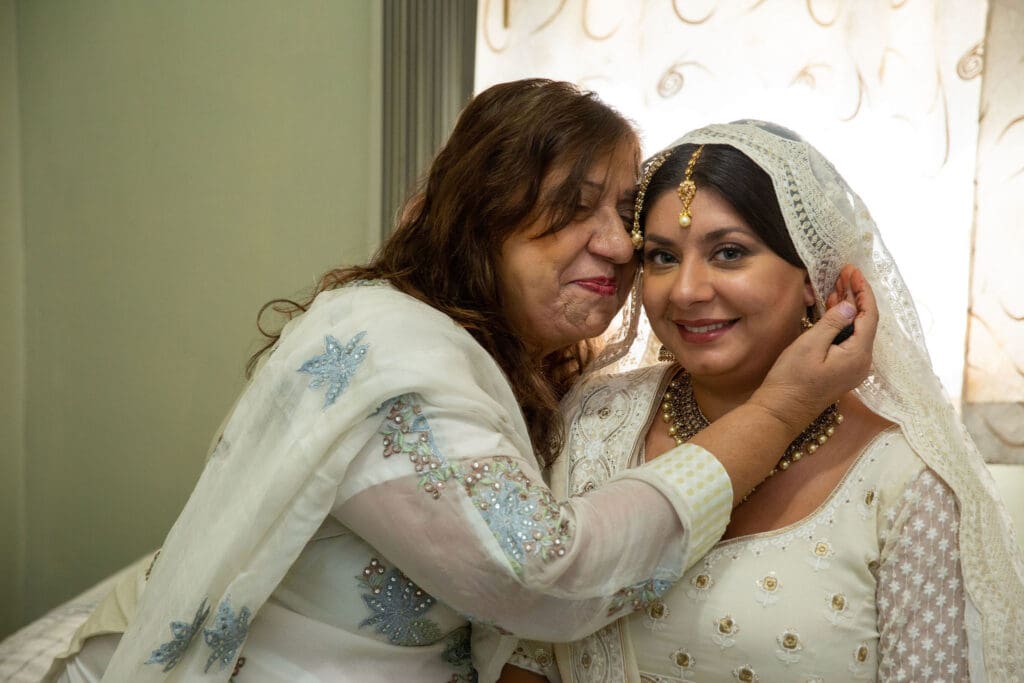 Brooklyn Nikkah Elopement. Portrait of bride and mother smiling before the ceremony in her full jewelry.