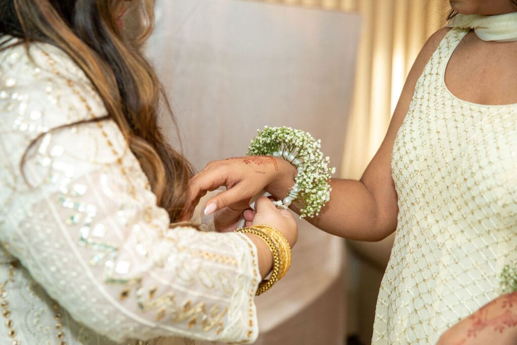 Brooklyn Nikkah Elopement. Mother of bride putting flowers on sister of bride before ceremony.