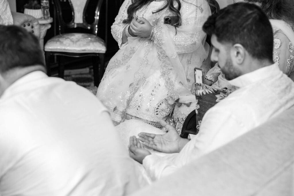Brooklyn Nikkah Elopement with Imam leading ceremony and close up of praying hands.