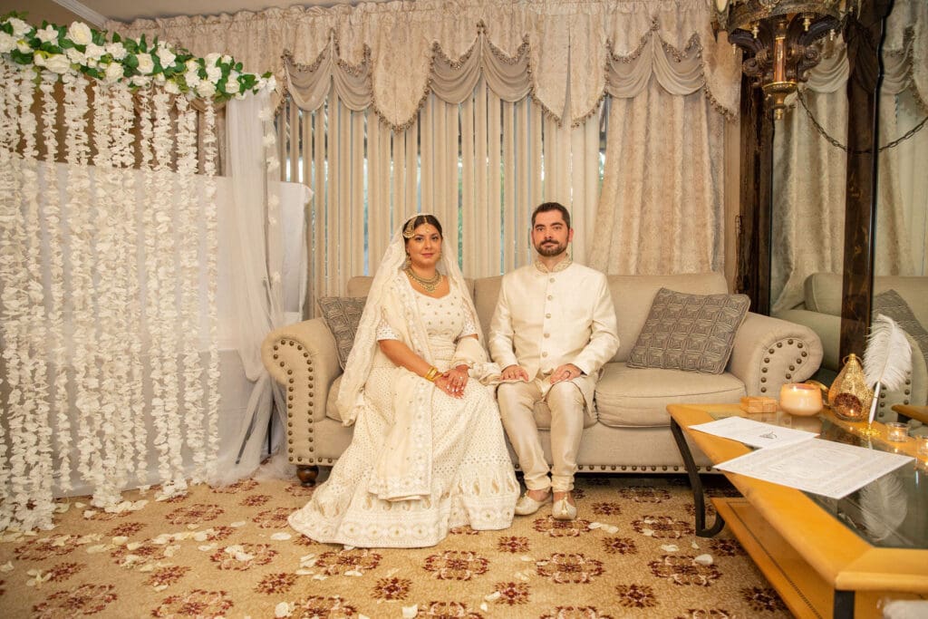 Brooklyn Nikkah Elopement with newlyweds posing for a portrait on a couch.