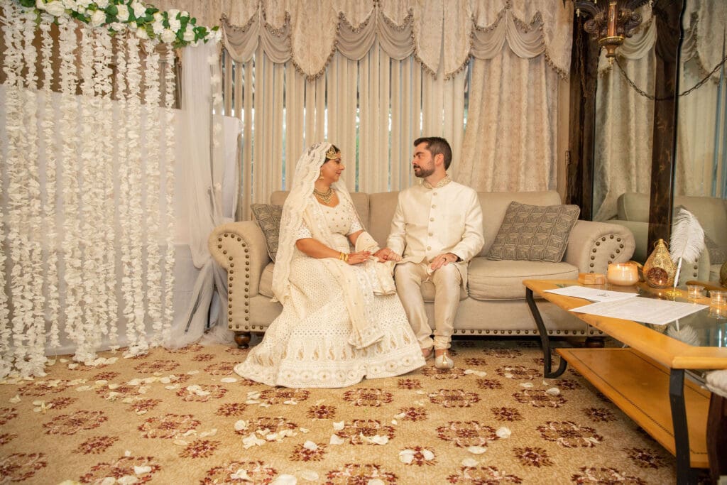 Brooklyn Nikkah Elopement with newlyweds posing for a portrait on a couch.