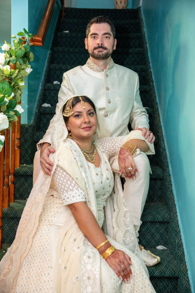 Brooklyn Nikkah Elopement with newlyweds seated on the stairs posing for a portrait.