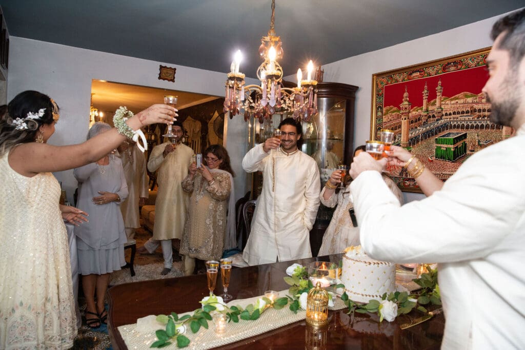 Brooklyn Nikkah Elopement with family raising a toast to the newlyweds.