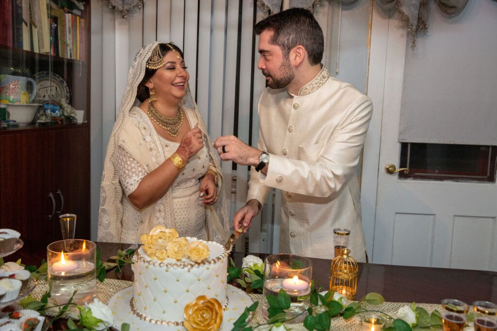 Brooklyn Nikkah Elopement with newlyweds feeding each other cake.