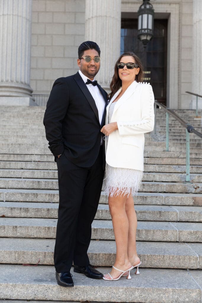 Newlywed couple pose at Supreme Court steps in NYC after getting married at City Hall.