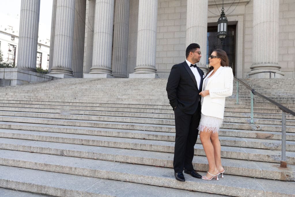 Newlywed couple pose at Supreme Court steps in NYC after getting married at City Hall.