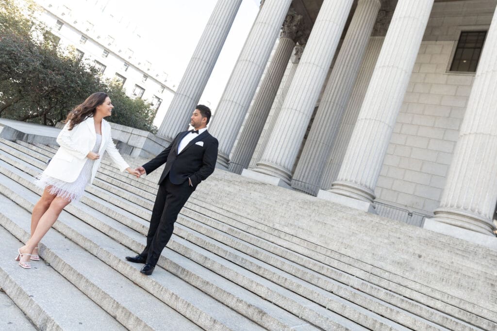 Newlywed couple pose at Supreme Court steps in NYC after getting married at City Hall.