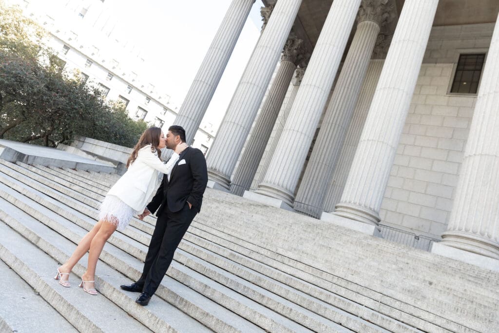 Newlywed couple pose at Supreme Court steps in NYC after getting married at City Hall.