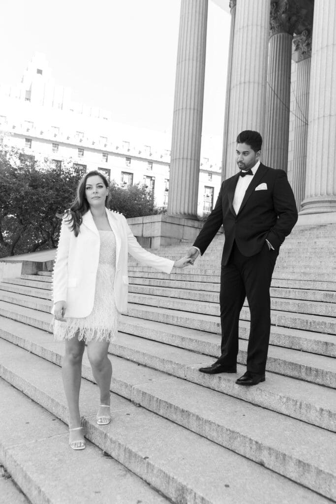 Newlywed couple pose at Supreme Court steps in NYC after getting married at City Hall. Black and White Image.