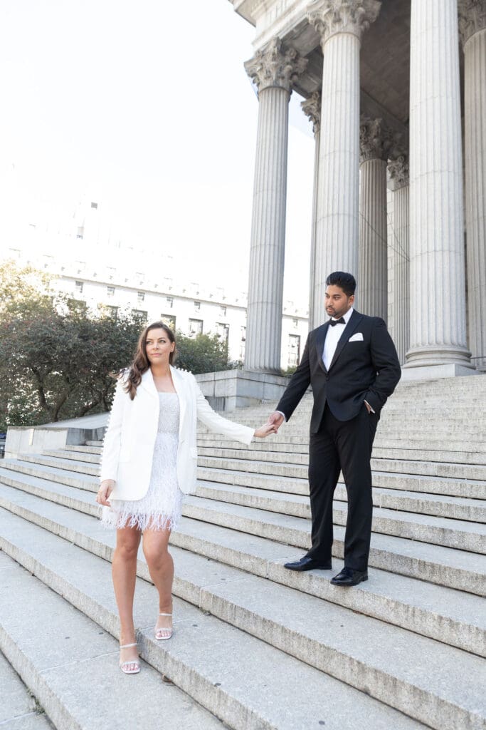 Newlywed couple pose at Supreme Court steps in NYC after getting married at City Hall.