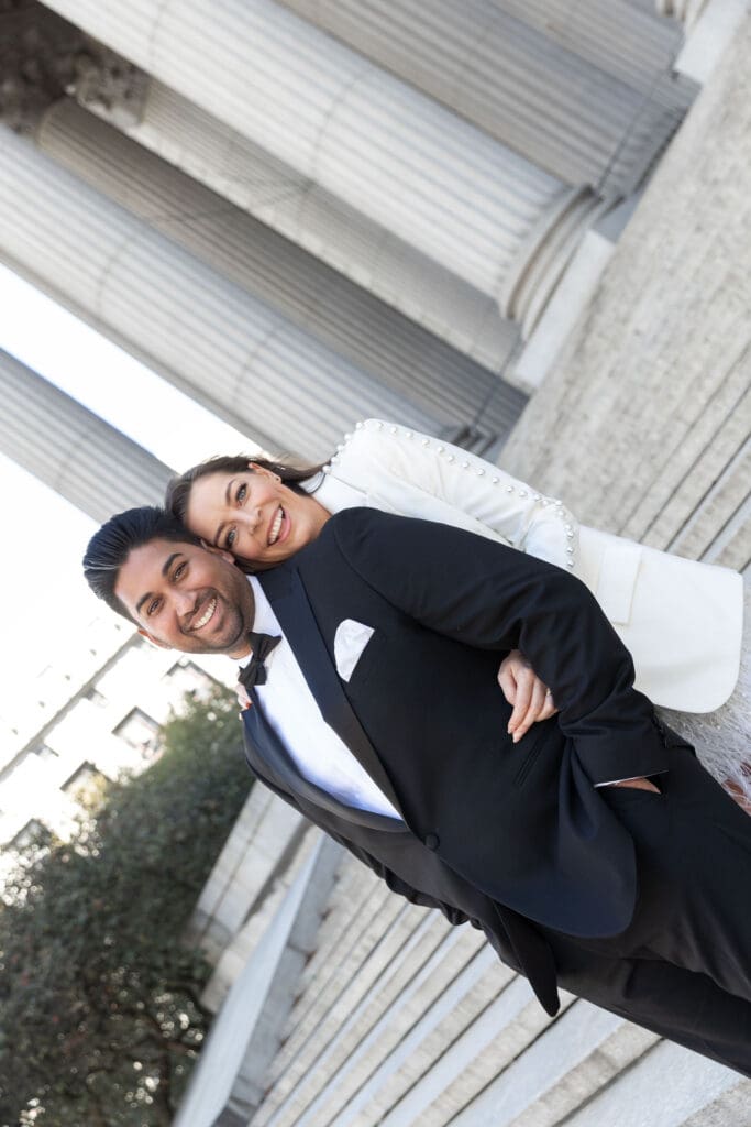 Newlywed couple laugh at Supreme Court steps in NYC after getting married at City Hall.