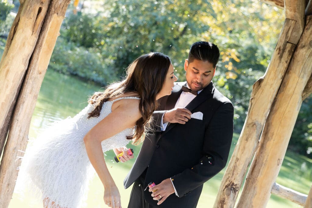 Newlywed couple pose at Wagner Cove in Central Park NYC after getting married at City Hall.