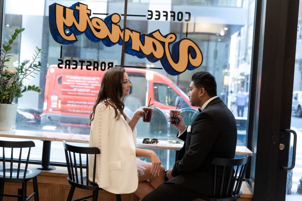 Newlywed couple gets coffee at Variety Coffee in NYC after getting married at City Hall.