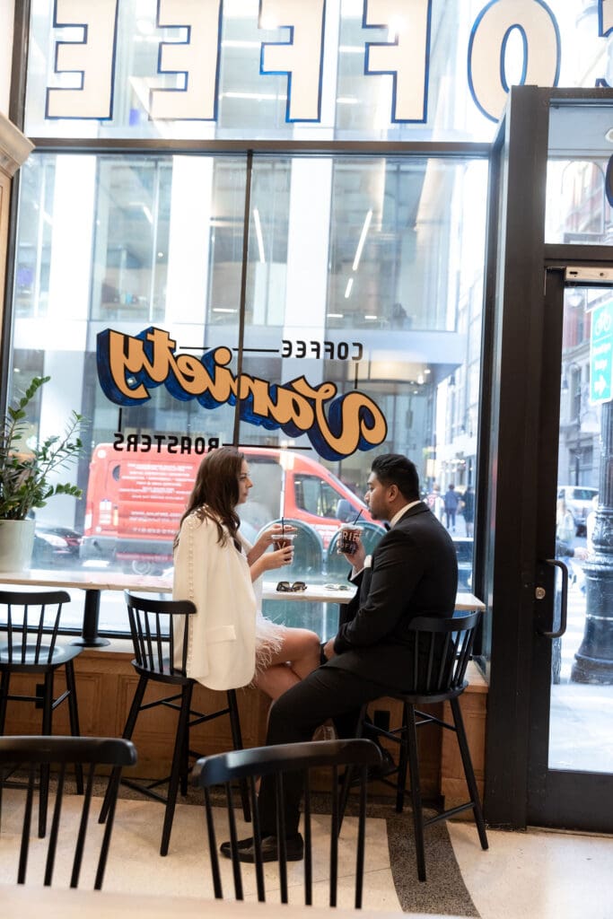 Newlywed couple gets coffee at Variety Coffee in NYC after getting married at City Hall.