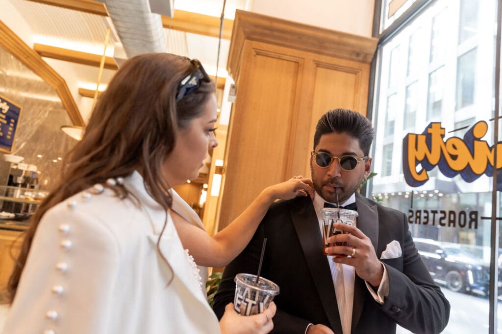 Newlywed couple gets coffee at Variety Coffee in NYC after getting married at City Hall.