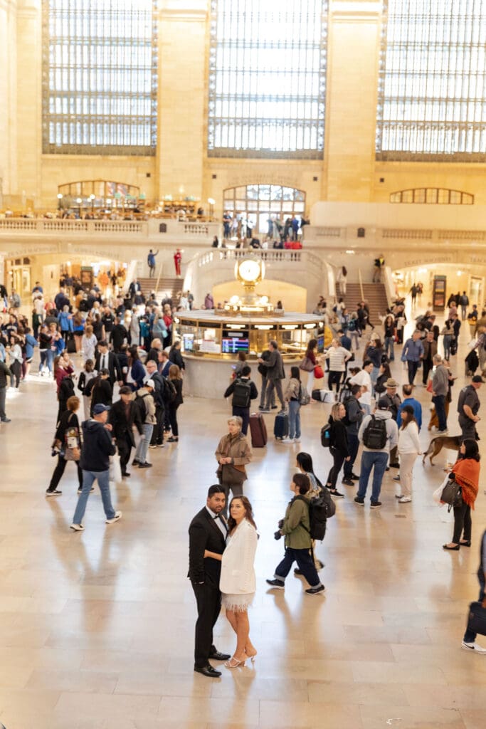 Fancy Newlywed UK couple pose inside Grand Central Station in NYC after getting married at City Hall.