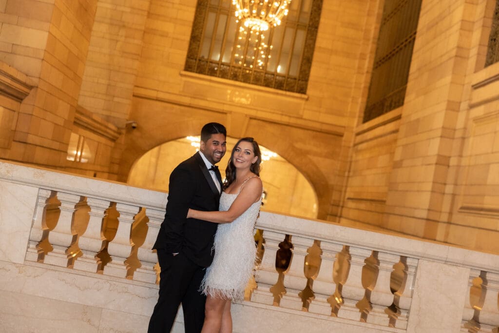 Fancy Newlywed UK couple laugh inside Grand Central Station in NYC after getting married at City Hall.
