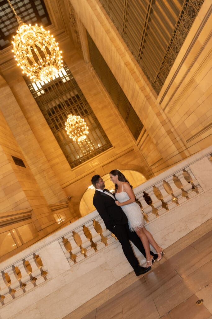 Fancy Newlywed UK couple pose inside Grand Central Station in NYC after getting married at City Hall.