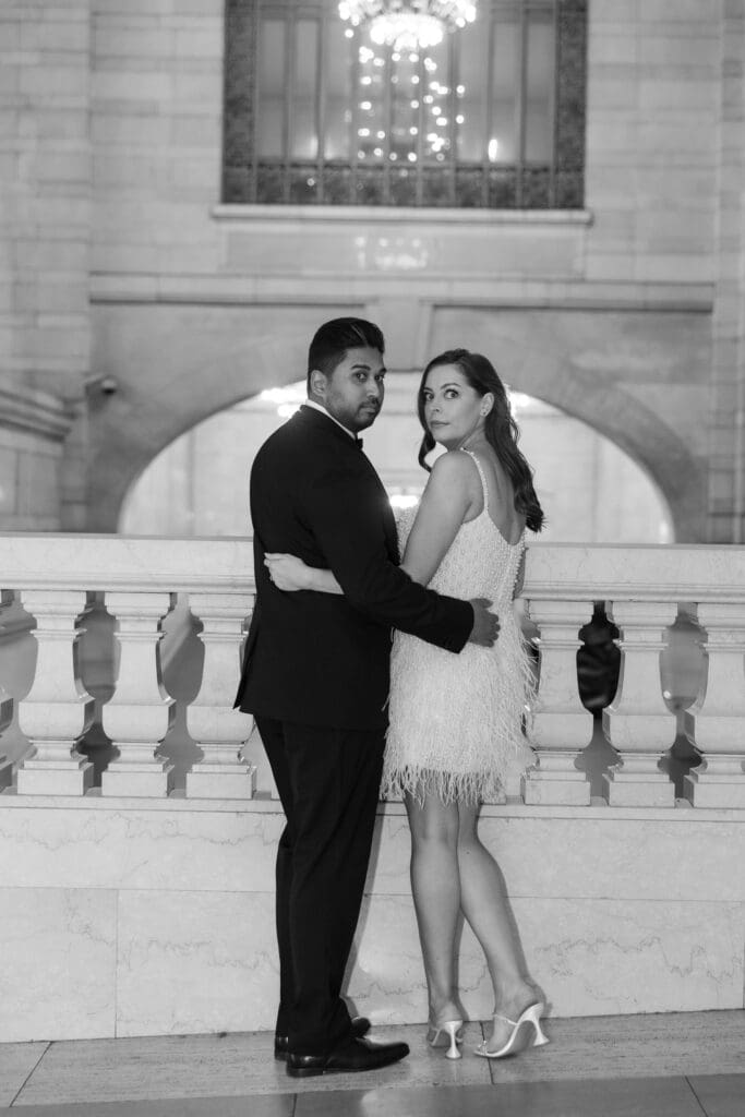 Fancy Newlywed UK couple pose inside Grand Central Station in NYC after getting married at City Hall. Black and White Image.