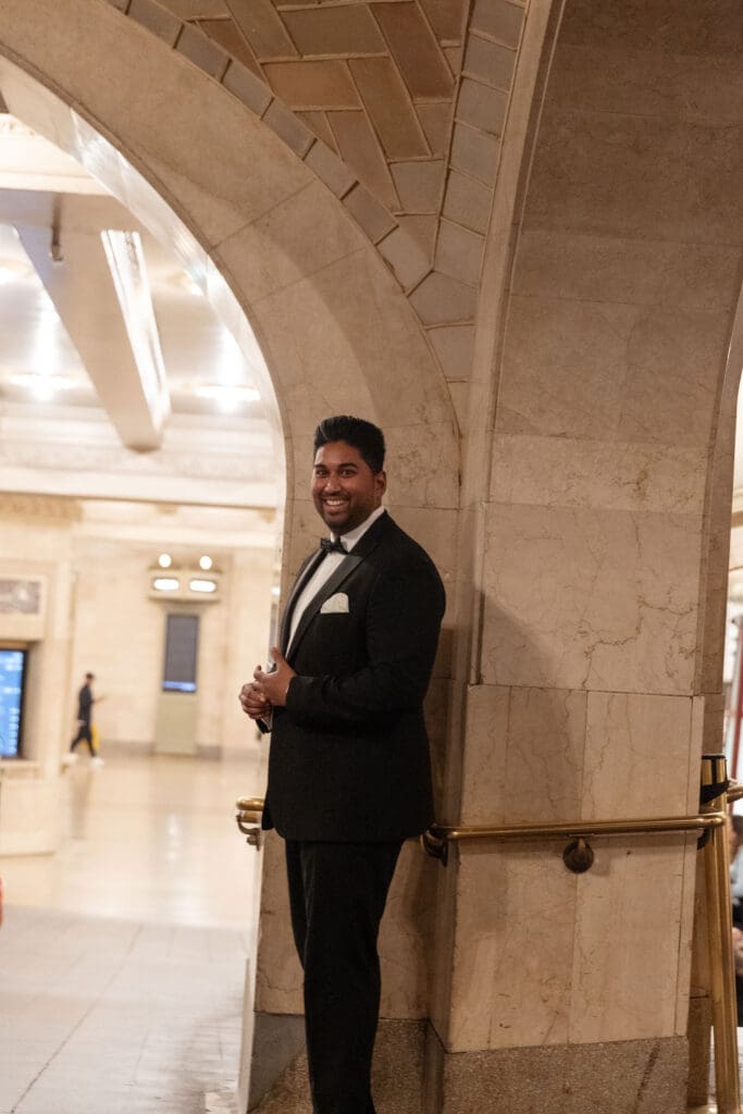 Newlywed UK couple use the whispering wall inside Grand Central Station in NYC after getting married at City Hall.