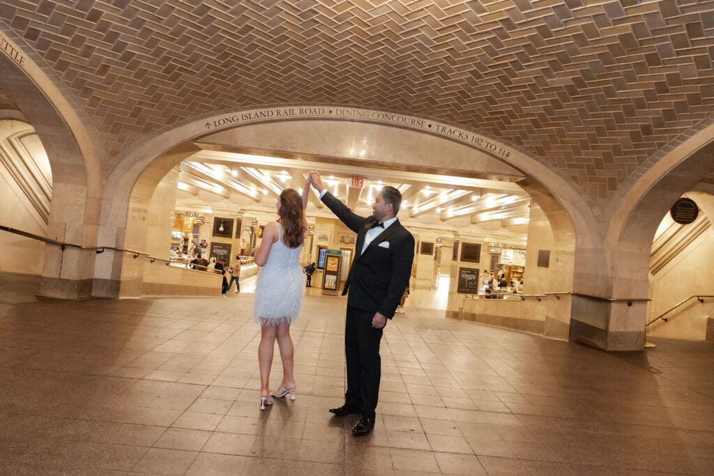 Fancy Newlywed UK couple dance inside Grand Central Station in NYC after getting married at City Hall.
