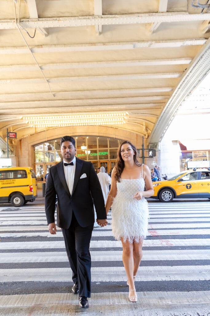 Newlywed UK couple cross the street outside Grand Central Station in NYC after getting married at City Hall.