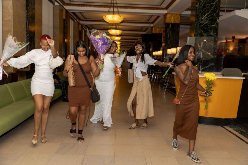 Two brides celebrate with their friends after getting married at NYC City Hall.