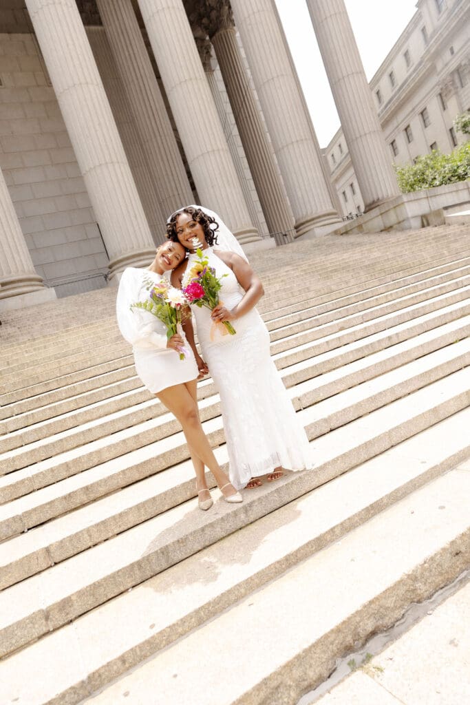 Two brides on the Supreme Court steps in NYC after getting married at City Hall.
