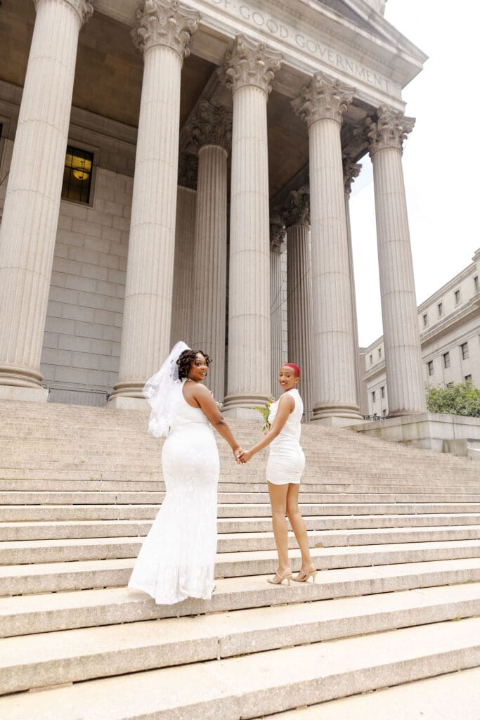 Two brides on the Supreme Court steps in NYC after getting married at City Hall.