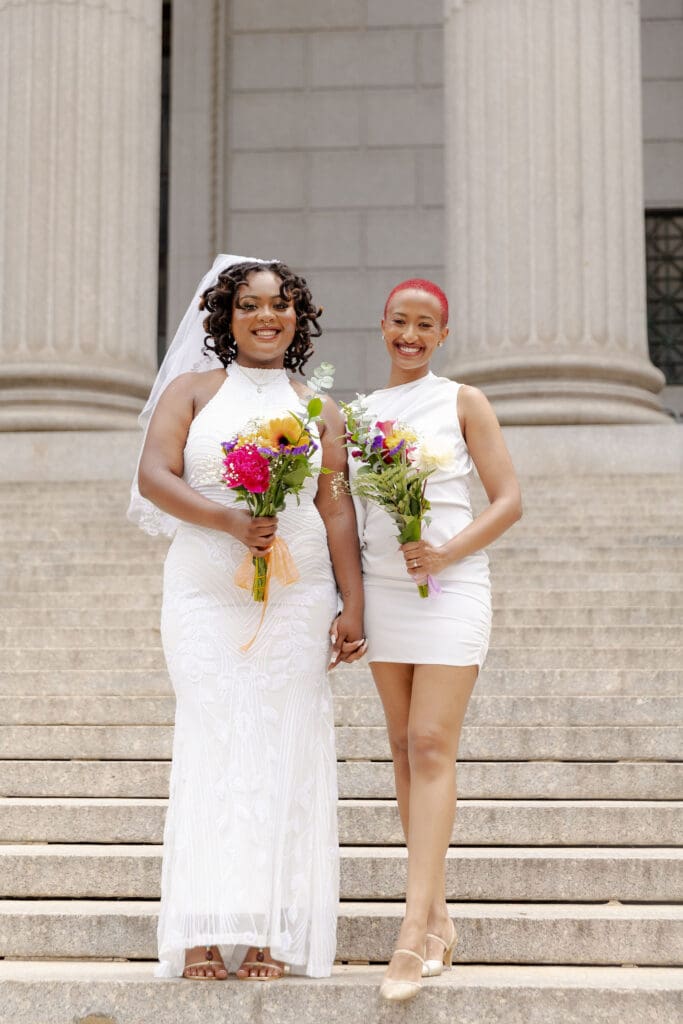Two brides on the Supreme Court steps in NYC after getting married at City Hall.