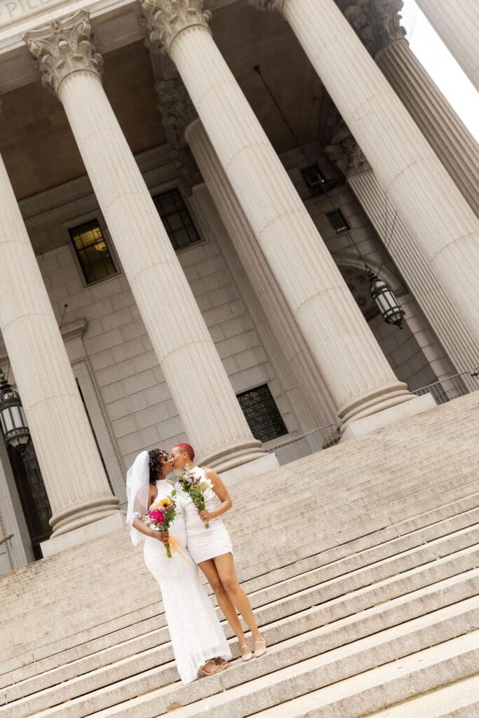 Two brides on the Supreme Court steps in NYC after getting married at City Hall.