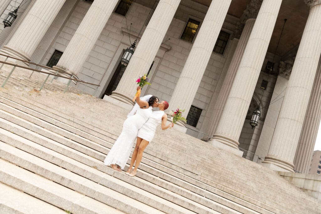Two brides on the Supreme Court steps in NYC after getting married at City Hall.