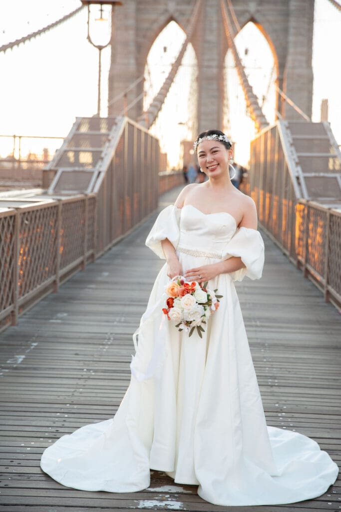 Bride poses at the Brooklyn Bridge in NYC. Black and White Image.