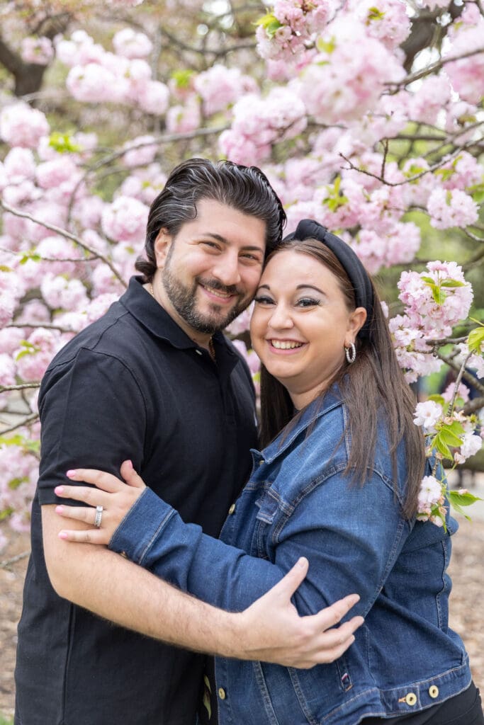 Newlywed couple take spring anniversary photos with the cherry blossoms at the Brooklyn Botanic Garden in Brooklyn, NY.