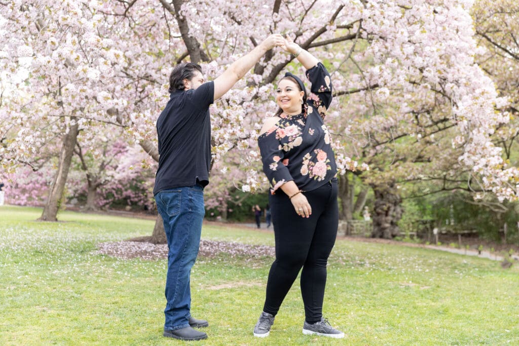 Newlywed couple take spring anniversary photos with the cherry blossoms at the Brooklyn Botanic Garden in Brooklyn, NY.