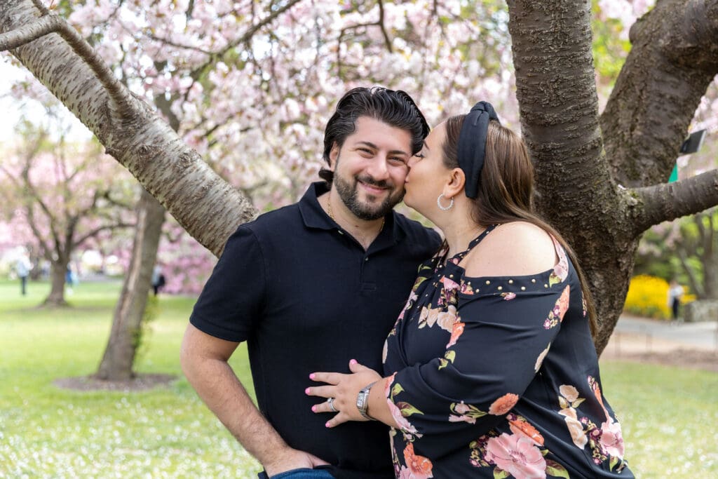 Newlywed couple take spring anniversary photos with the cherry blossoms at the Brooklyn Botanic Garden in Brooklyn, NY.