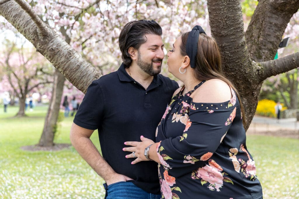 Newlywed couple take spring anniversary photos with the cherry blossoms at the Brooklyn Botanic Garden in Brooklyn, NY.