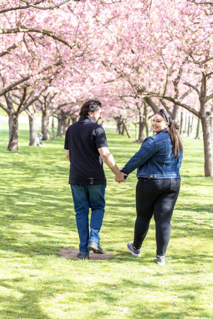 Newlywed couple take spring anniversary photos with the cherry blossoms at the Brooklyn Botanic Garden in Brooklyn, NY.