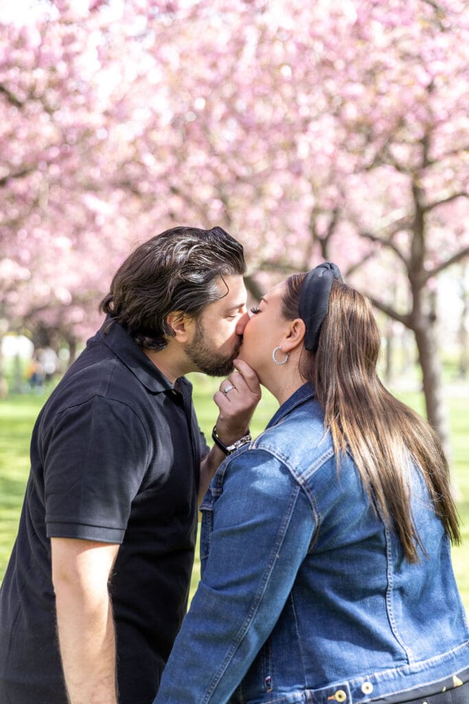 Newlywed couple take spring anniversary photos with the cherry blossoms at the Brooklyn Botanic Garden in Brooklyn, NY.