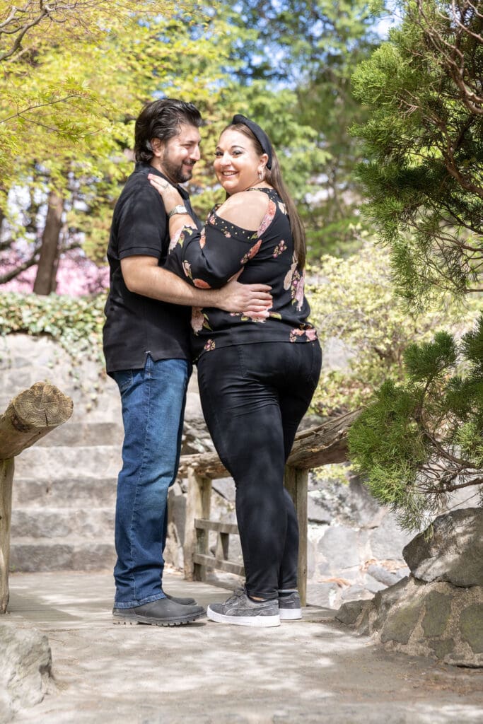 Newlywed couple take spring anniversary photos in the Japanese Garden with the cherry blossoms at the Brooklyn Botanic Garden in Brooklyn, NY.