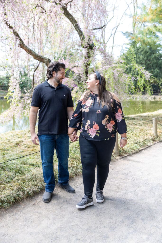 Newlywed couple take anniversary photos in the Japanese Garden with the cherry blossoms at the Brooklyn Botanic Garden in Brooklyn, NY.