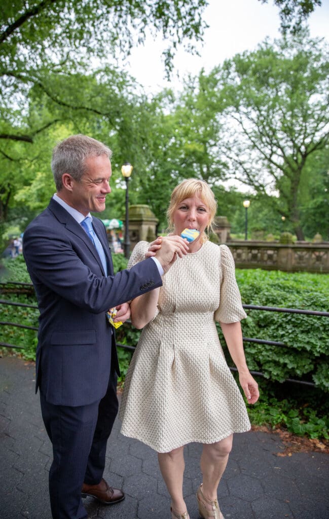 NYC Elopement in Central Park after after ceremony at the Norwegian Seamen's Church. Bride and groom eat ice cream in the park.