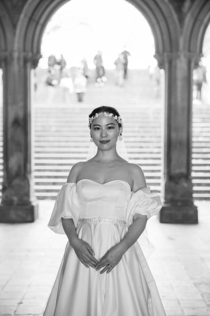 Newlyweds pose at the Arcade at Bethesda Terrace in NYC's Central Park.