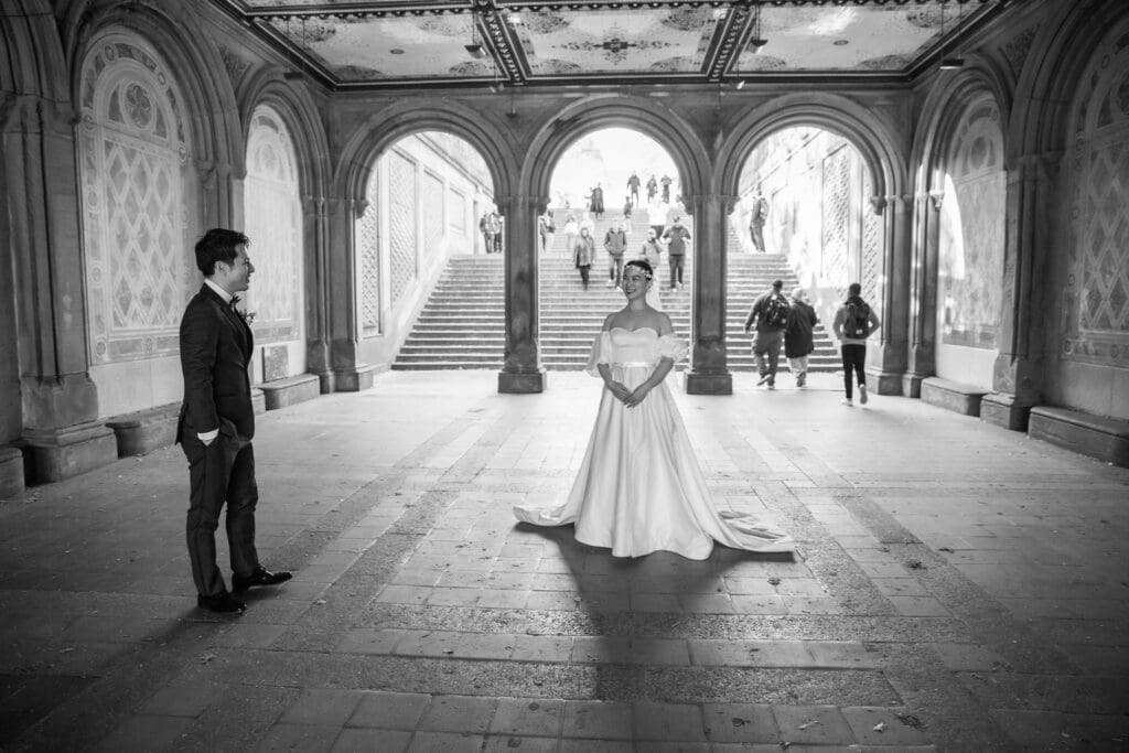 Newlyweds pose at the Arcade at Bethesda Terrace in NYC's Central Park.