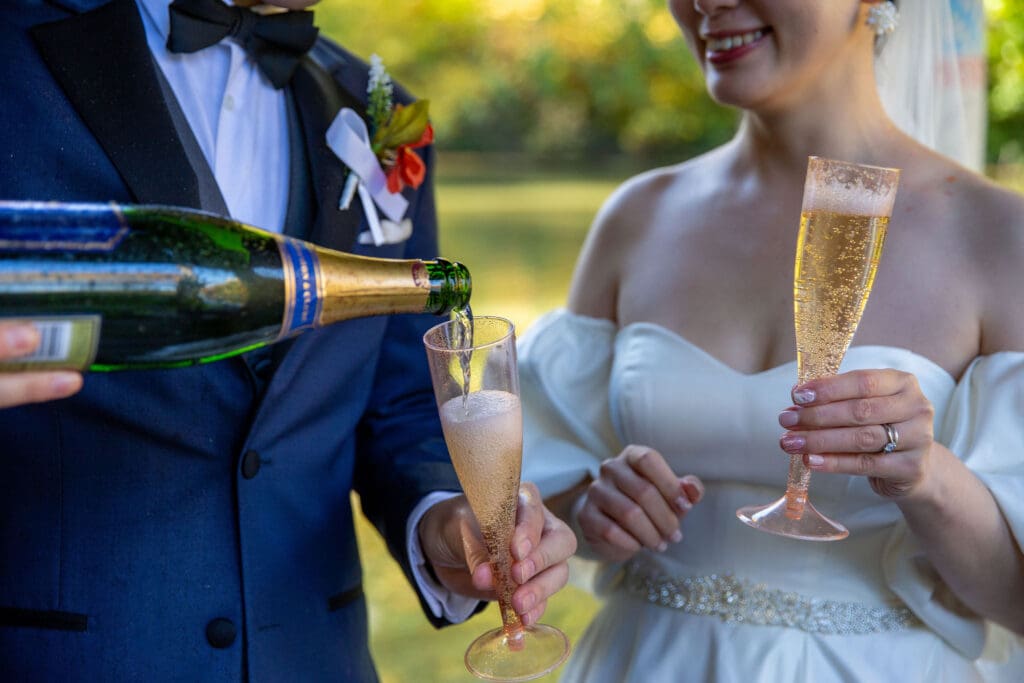 Newlyweds pop champagne at Wagner Cove in NYC's Central Park.