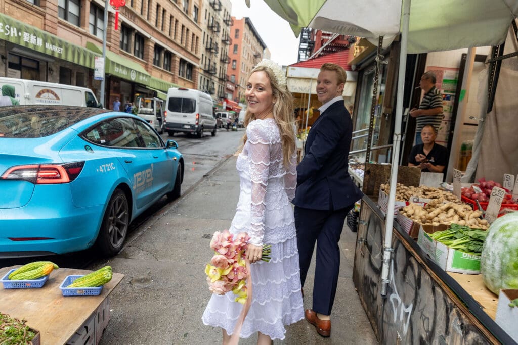 Newlyweds take wedding portraits along Mott St in Chinatown NYC.